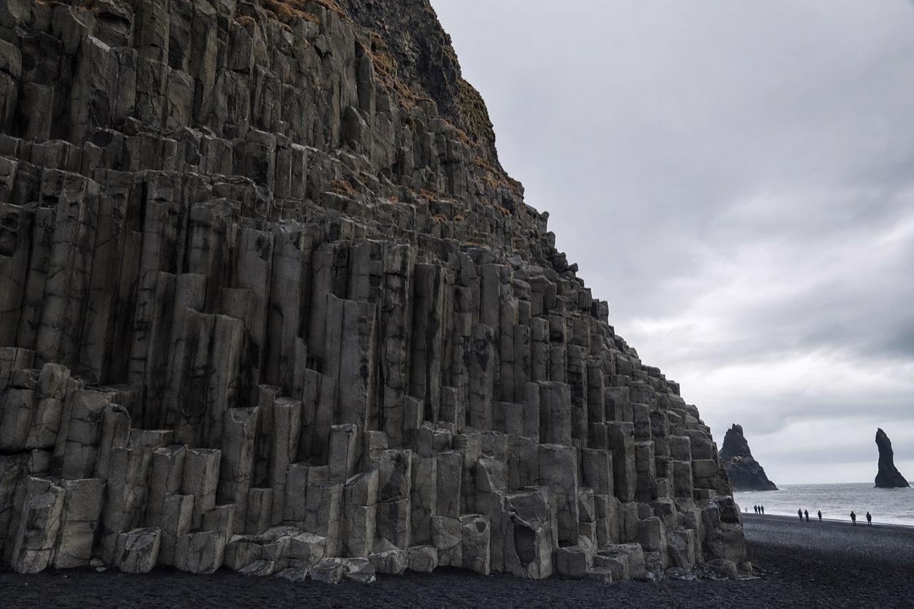 The hexagonal basalt columns (Gardar) at Reynisfjara black sand beach, with sea stacks offshore