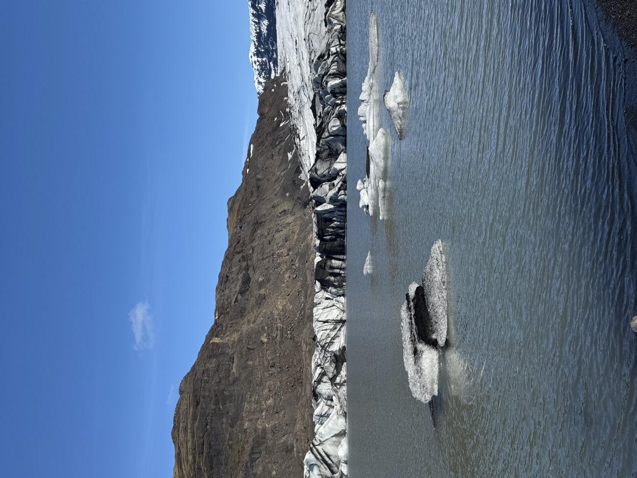 Black pebbles and Atlantic surf at Reynisfjara black sand beach, a stop on the South Coast day tour from Reykjavik