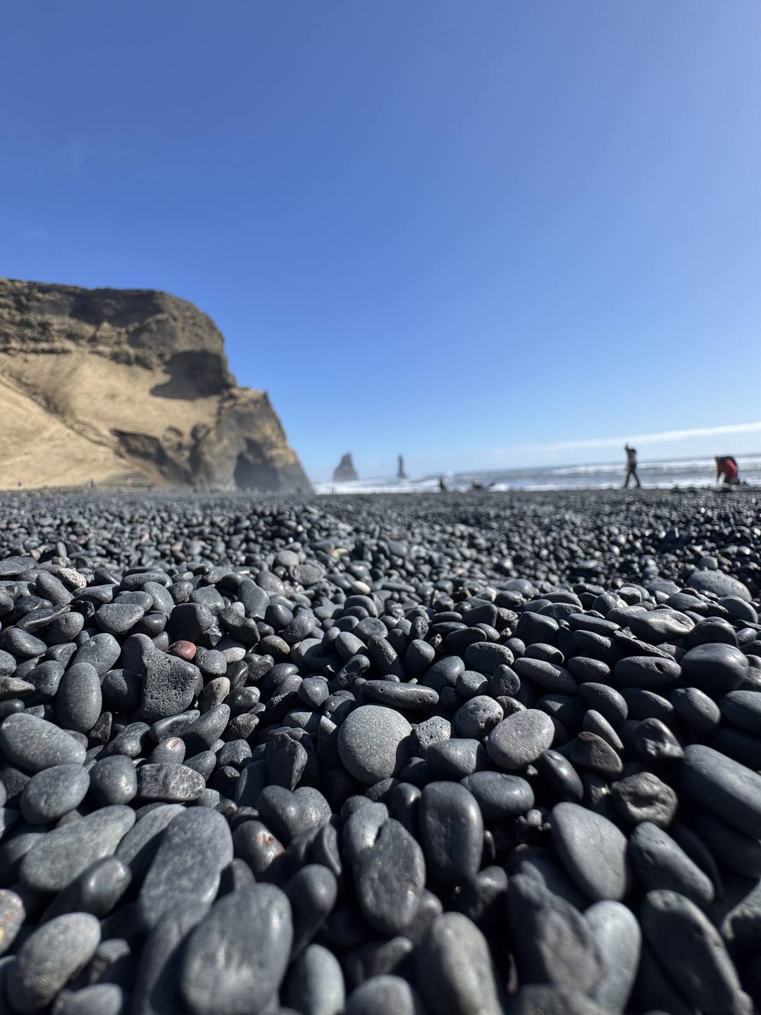 The Reynisdrangar basalt sea stacks rising from the ocean off Reynisfjara black sand beach
