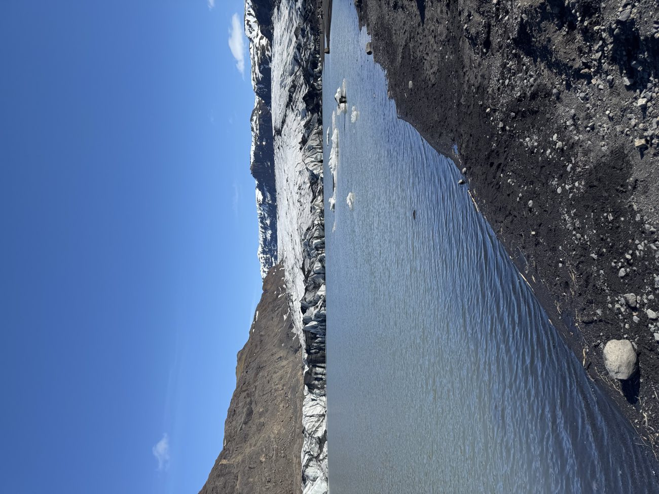 Atlantic waves washing up the black sand at Reynisfjara, where sneaker waves make the shoreline dangerous
